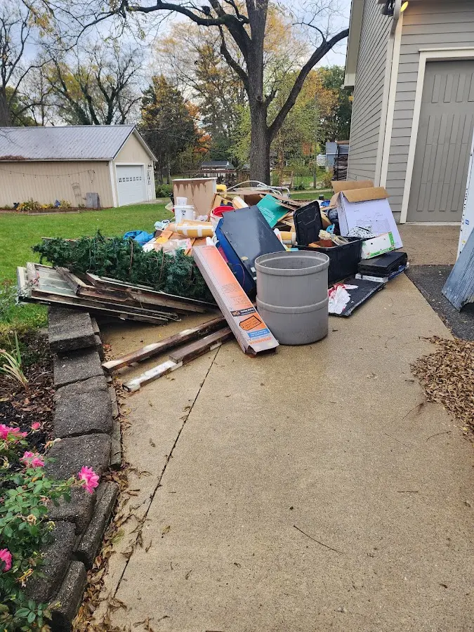 Dumpster being loaded with debris for 12 Yard Dumpster Rental in Wilton